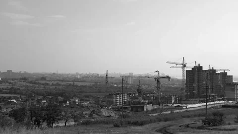 Several tower cranes build a multi-storey building and move cargo, long-range pl Stock-Footage 113423368