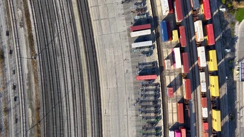 Several Train tracks , colorful containers, container chassis at logistics .. Video stock 322942273