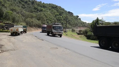 Several trucks and vehicles driving on B3, Rift Valley, Kenya Stock Footage 82575363