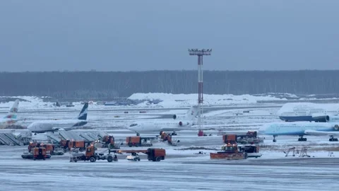 Several trucks remove snow from runways on airdrome of Domodedovo airport at Stock Footage 276369660