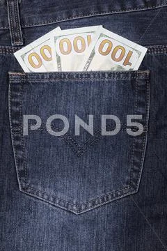 Several Twenty Dollar Bills In The Pocket Of A Pair Of Jeans