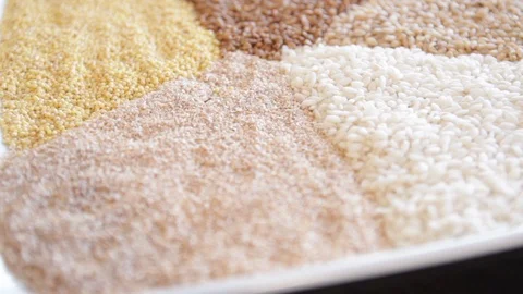 Several types of cereals on one plate. buckwheat, rice, millet, barley. close-up Stock Footage 114705770