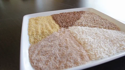 Several types of cereals on one plate. buckwheat, rice, millet, barley, quinoa. Video stock 114739845