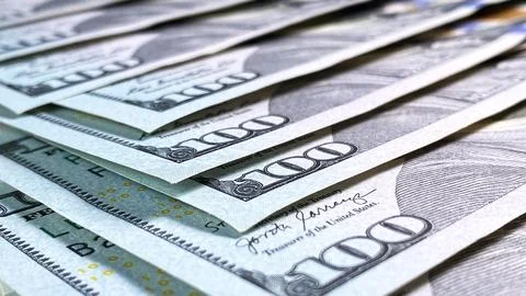 Several US$ 100 bills are stacked on top of each other, close-up. The Ameri.. Stock Photos