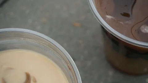 Several varieties of cold coffee with a straw in a plastic cup, close-up. Stock Footage 299735433
