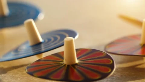 Several whirligigs spin around her own axis on the table. Stock Footage 172575908