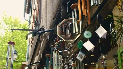 Several Wind Chimes and Optical Patterns hanging outside a house Stock Footage 101347182