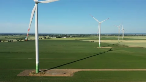 Several wind turbines (windmill) are spinning on the field, taken from a drone, Stock Footage 245456370