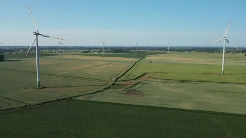 Several wind turbines (windmill) are spinning on the field, taken from a drone, Stock Footage 245456380