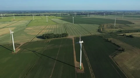 Several wind turbines (windmill) are spinning on the field, taken from a drone, Stock Footage 245456395