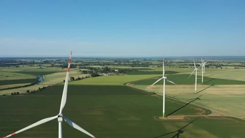 Several wind turbines (windmill) are spinning on the field, taken from a drone, Stock Footage 245456396