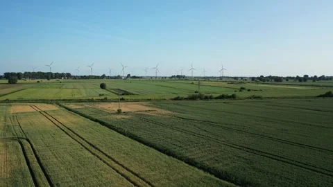 Several wind turbines (windmill) are spinning on the field, taken from a drone, Stock Footage 245482922