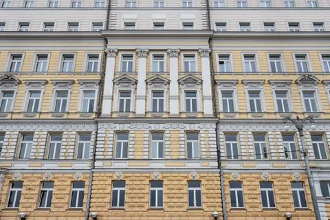 Several Windows in a row on the facade of the old building. Windows in a row Stock Photos