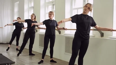 Several women do dance exercises at the ballet barre. Stock Footage 239691228