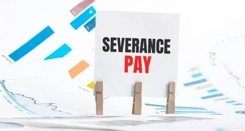 Severance pay text on paper sheet with chart, dice, spectacles, pen, laptop a Stock Photos