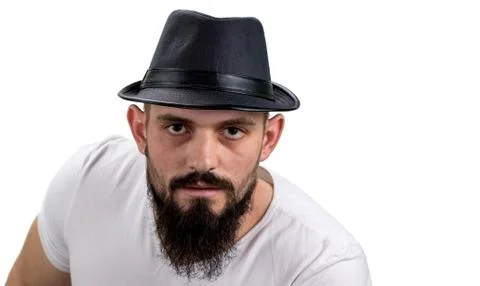 Severe bearded man in hat looking at camera isolated on white background. Wit Stock Photos