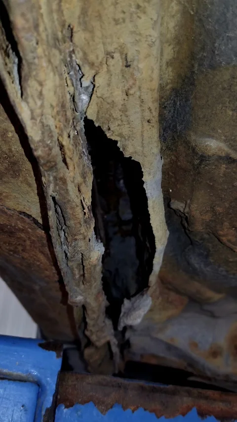 Severe corrosion and rust hole in a car metal chassis Stock Footage 334321645