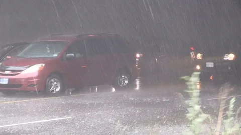 Severe hail rain wind and thunderstorm with cars trapped on city streets Stock Footage 77410437