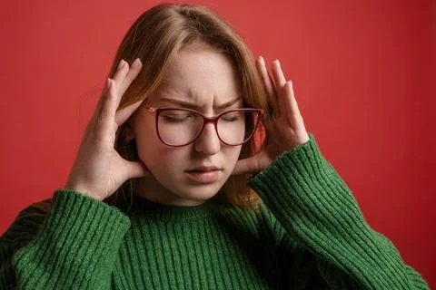 Severe headache, brain spasm, portrait of a girl with glasses squeezing her.. Stock Photos