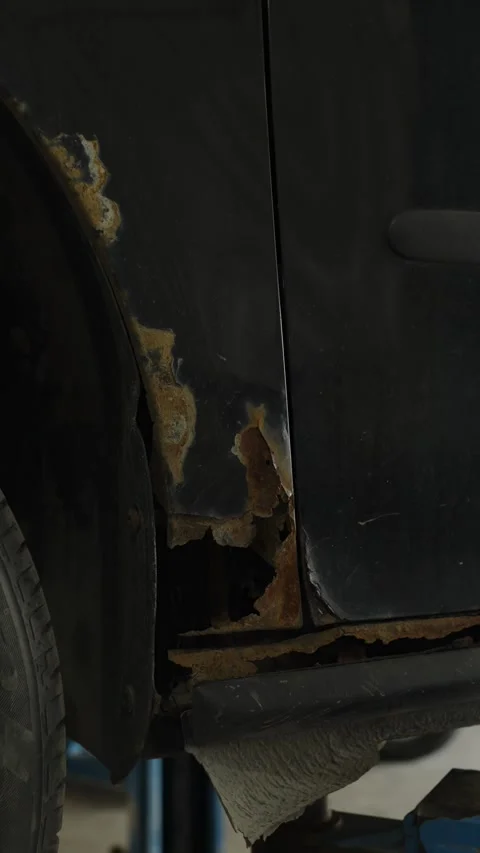 Severe rust and corrosion damage on a black car fender 스톡 동영상 340154213