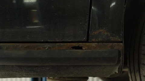 Severe rust and a hole on a black car rocker panel 스톡 동영상 340154320
