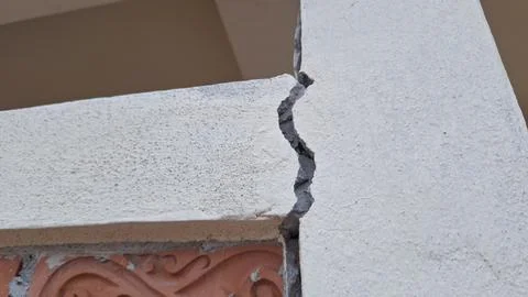 Severe structural crack between concrete beam and wall Stock Photos