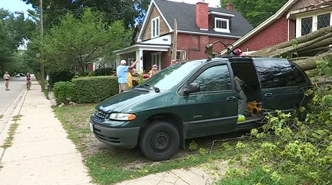 Severe thunderstorm damage with car crushed by tree Stock Footage 55853024