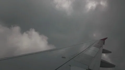Severe turbulence when flying through thunderstorm clouds. The wing is very Video stock 103433814