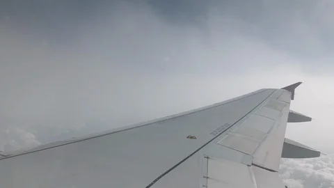 Severe turbulence when landing through thunderstorm clouds. Wing strongly Stock Footage 103516043