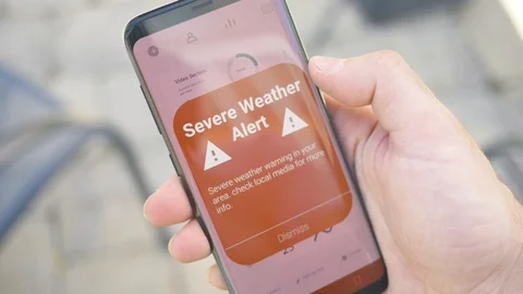 Severe Weather Alert Notification on a Smartphone Mobile Screen Stock Footage