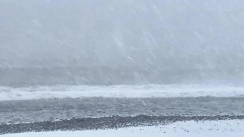 Severe winter snowstorm over rough sea with high waves during blizzard. Stock Footage 319146031