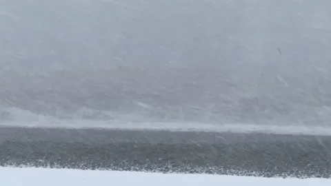 Severe winter snowstorm over rough sea with high waves during blizzard Stock Footage 319146054