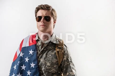 Severe young male soldier frowning Stock Photos