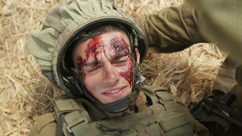 Severely wounded soldier with multiple large blood wounds to his face Stock Footage 169262228