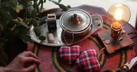 Sew on button in center of stuffed heart, making Valentine heart decor Stock Footage 170090033