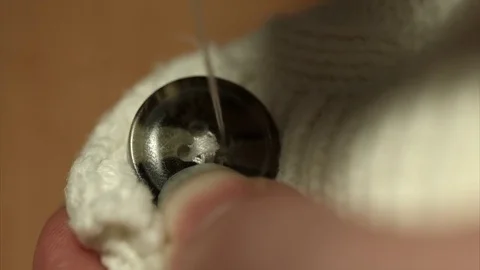 Sew on a button Stock Footage 75710049