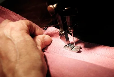 To sew a material on the sewing machine Stock Photos