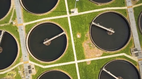 Sewage Farm: circular settling tanks - descending, vertical aerial drone Stock Footage