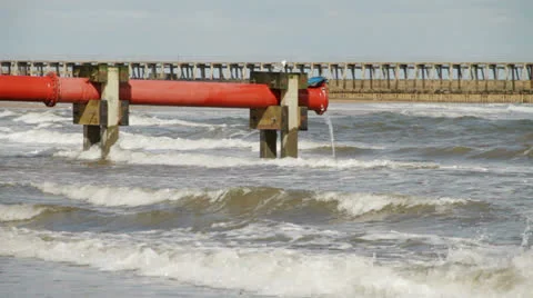 Sewage pipe out at sea with waves Stock Footage 22482319