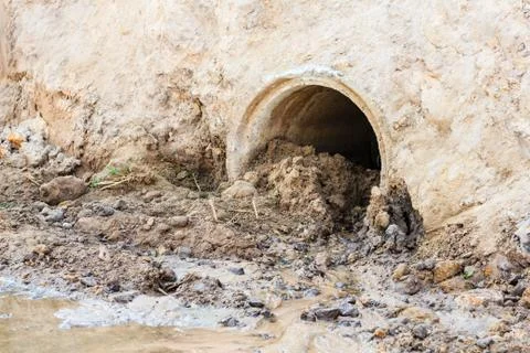 Sewage pipe polluting the river Stock Photos