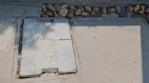 Sewer Cover Embedded in Concrete Road Stock Footage 323344562