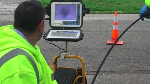 Sewer drain cleaning, pushing camera cable into sewer Stock-Footage 59738119