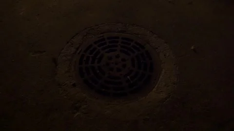 Sewer drain manhole cover grating holes metal night street light Terrassa Stock Footage 340896946