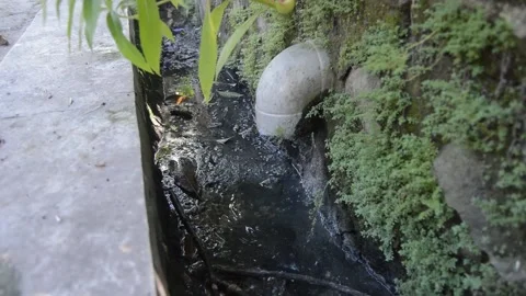 Sewer flow with a water drain pipe into the sewer 库存影片 177144478