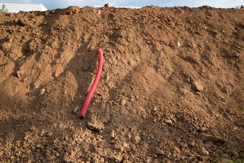Sewer pipe removed from the ground during the construction phase. Cable channel Stock Photos