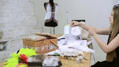Sewer putting thread in sewing machine preparation in atelier Stock Footage 74160416