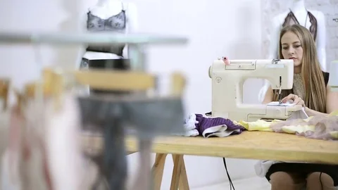 Sewer putting thread in sewing machine preparation in atelier Stock Footage 78631522