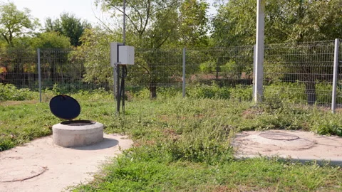 Sewerage maintenance scene showcasing sequential frames of an open manhole cover Stock Footage 319530147