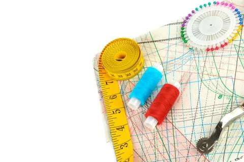 Sewing accessories and paper pattern isolated on white background. Top view. Stock-Fotos