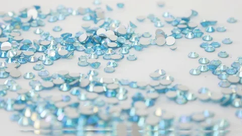 Sewing Accessories Macro. Shiny blue rhinestones on a white background Stock Footage 122805043